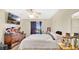 Cozy bedroom features a large window, dresser, ceiling fan, and neutral color scheme at 37149 Sandy Ln, Grand Island, FL 32735