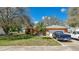 Charming single-story home with mature trees and a well-maintained lawn in a desirable neighborhood at 37149 Sandy Ln, Grand Island, FL 32735