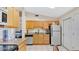 Traditional kitchen with granite countertops, white appliances, and light wood cabinets at 37149 Sandy Ln, Grand Island, FL 32735
