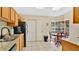 Functional kitchen with granite countertops, white cabinetry, and a cozy breakfast nook area at 37149 Sandy Ln, Grand Island, FL 32735