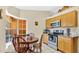Eat-in kitchen features wood table, natural light, and matching wood cabinets at 37149 Sandy Ln, Grand Island, FL 32735
