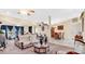 Open-concept living room with a comfortable sofa, neutral decor, and a view into the dining area at 37149 Sandy Ln, Grand Island, FL 32735