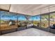 Screened patio overlooking a large field with mature trees at 37149 Sandy Ln, Grand Island, FL 32735