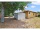 Backyard view featuring a storage shed and ample yard space with mature trees at 3823 Ryegrass St, Clermont, FL 34714