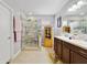 Bathroom features dual sinks, walk-in shower, and natural light at 3823 Ryegrass St, Clermont, FL 34714