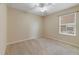 Cozy bedroom featuring a ceiling fan, carpeted floor, and natural light at 3823 Ryegrass St, Clermont, FL 34714