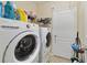 Bright laundry room with modern washer and dryer and ample storage space at 3823 Ryegrass St, Clermont, FL 34714