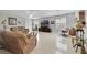 Bright living room featuring tile floors, comfortable brown sofas, and a large television at 3823 Ryegrass St, Clermont, FL 34714