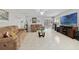 Spacious living room featuring neutral walls, tile floors, comfortable sofas, and a ceiling fan at 3823 Ryegrass St, Clermont, FL 34714