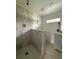 Bathroom featuring gray-toned shower tile, modern vanity, neutral walls and stylish wood-look flooring at 3931 Avenue R Nw, Winter Haven, FL 33881