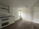 This kitchen boasts new appliances, wood-look flooring, and a bright, spacious area with natural light at 3931 Avenue R Nw, Winter Haven, FL 33881