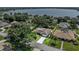 Aerial view of home, highlighting its location, well-manicured lawn, and proximity to a lake at 415 Flagler Rd, Winter Haven, FL 33884