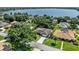 An aerial view of a beautiful home with a lush backyard and a stunning lake in the background at 415 Flagler Rd, Winter Haven, FL 33884