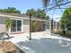 Spacious backyard featuring a concrete patio, landscaping, and access to an enclosed pool area at 415 Flagler Rd, Winter Haven, FL 33884