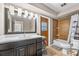 Bright bathroom featuring a large vanity, modern lighting and tiled shower/bath combo at 415 Flagler Rd, Winter Haven, FL 33884