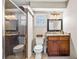 Bathroom featuring a walk-in shower, a vanity with a sink, and a toilet at 415 Flagler Rd, Winter Haven, FL 33884
