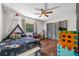 The bedroom features hardwood floors, a ceiling fan, and a window at 415 Flagler Rd, Winter Haven, FL 33884