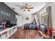 A spacious bedroom featuring hardwood floors, a ceiling fan, and a window at 415 Flagler Rd, Winter Haven, FL 33884