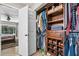 Walk-in closet with custom shelving and a view of the bedroom at 415 Flagler Rd, Winter Haven, FL 33884