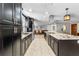 Well-equipped kitchen featuring sleek cabinetry, granite countertops, stainless steel appliances, and a large central island at 415 Flagler Rd, Winter Haven, FL 33884