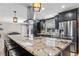 The kitchen features dark cabinets, a stainless steel refrigerator, and a large island with seating at 415 Flagler Rd, Winter Haven, FL 33884