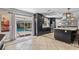Bright kitchen with dark cabinets, a large island, and sliding glass doors to the screened-in pool at 415 Flagler Rd, Winter Haven, FL 33884