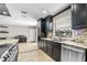 Kitchen area features dark cabinets, granite countertops, and stainless steel appliances at 415 Flagler Rd, Winter Haven, FL 33884