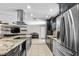 Open kitchen with stainless steel appliances, granite countertops, and access to the living room at 415 Flagler Rd, Winter Haven, FL 33884