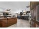 Inviting living room with an open layout, tile floors, a ceiling fan, and barstool seating at the kitchen island at 415 Flagler Rd, Winter Haven, FL 33884
