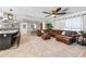 Open living space featuring an expansive leather sectional and seamless flow into the kitchen and dining area at 415 Flagler Rd, Winter Haven, FL 33884