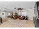 Open living room showcasing a large leather sectional, neutral decor, and tile flooring at 415 Flagler Rd, Winter Haven, FL 33884