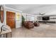 Spacious living room featuring a large leather sectional, tile floors, and a decorative rug at 415 Flagler Rd, Winter Haven, FL 33884