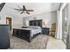 Spacious main bedroom with a large bed, dark furniture, a ceiling fan, and a decorative chair at 415 Flagler Rd, Winter Haven, FL 33884
