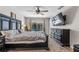 Cozy main bedroom with a large bed, dark furniture, a ceiling fan, and sliding glass doors to the pool at 415 Flagler Rd, Winter Haven, FL 33884