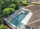 Aerial view of the screened-in pool area, including a pool with a raft, and outdoor setting at 415 Flagler Rd, Winter Haven, FL 33884