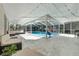 Screened-in pool area with outdoor seating, swing, and covered patio space at 415 Flagler Rd, Winter Haven, FL 33884