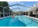 Sparkling pool with screened-in enclosure and outdoor seating area at 415 Flagler Rd, Winter Haven, FL 33884