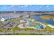 An aerial view highlights the community pool, lazy river, and amenities nestled within a well-planned neighborhood at 4338 Rhyme St, Kissimmee, FL 34746
