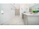 Bright bathroom featuring double sinks, and a glass enclosed shower at 4338 Rhyme St, Kissimmee, FL 34746