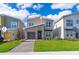 Beautiful two-story home with a modern design, stone accents, well-manicured lawn, and inviting curb appeal at 4338 Rhyme St, Kissimmee, FL 34746