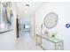 Entryway featuring white walls, marble tile, modern decor, and a view into the bright living space at 4338 Rhyme St, Kissimmee, FL 34746