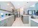 Modern kitchen with gray cabinets, stainless steel appliances, and quartz countertops at 4338 Rhyme St, Kissimmee, FL 34746