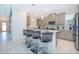 Modern kitchen featuring an island with seating, stainless steel appliances, and grey cabinetry at 4338 Rhyme St, Kissimmee, FL 34746