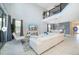 Spacious living area featuring high ceilings, large windows, modern furnishings, and a stylish accent wall at 4338 Rhyme St, Kissimmee, FL 34746