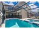 A stunning, screened-in pool and spa offer a relaxing outdoor retreat with a private backyard oasis at 4338 Rhyme St, Kissimmee, FL 34746