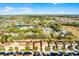 Aerial view of a home with a terracotta tile roof in a neighborhood with community lakes at 5260 Oakbourne Ave, Davenport, FL 33837