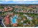 An aerial view of the community pool with palm trees and chairs at 5260 Oakbourne Ave, Davenport, FL 33837