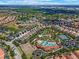 A captivating aerial shot highlights the community pool, tennis courts, and lush landscaping at 5260 Oakbourne Ave, Davenport, FL 33837