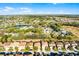 Wide aerial shot of homes in a community near a lake, surrounded by lush greenery under a sunny sky at 5260 Oakbourne Ave, Davenport, FL 33837