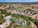 Aerial view featuring the community's lazy river, pool area, and lush tropical landscaping at 5260 Oakbourne Ave, Davenport, FL 33837